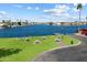 An aerial view of a waterfront park with picnic tables and lush green grass for gatherings at 14610 N 87Th Ave, Peoria, AZ 85381