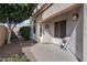 Inviting front porch with decorative wreath and flower arrangement and cozy seating arrangement at 14610 N 87Th Ave, Peoria, AZ 85381
