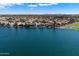 A stunning waterfront view of homes along the lake, complemented by a serene body of water at 14610 N 87Th Ave, Peoria, AZ 85381