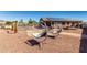 Landscaped backyard with desert decor and a fenced pool and seating area at 14846 N 145Th Ave, Surprise, AZ 85379