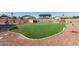 Large backyard featuring an artificial grass lawn, playground, and a fenced pool, perfect for outdoor fun at 14846 N 145Th Ave, Surprise, AZ 85379