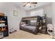 Bedroom with built-in bunk beds featuring integrated storage and a ceiling fan at 14846 N 145Th Ave, Surprise, AZ 85379