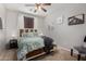 Comfortable bedroom with a decorative bed frame, ceiling fan and neutral decor at 14846 N 145Th Ave, Surprise, AZ 85379