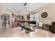 Gorgeous kitchen with stainless steel appliances, kitchen island with bar stools, and a large dining table at 14846 N 145Th Ave, Surprise, AZ 85379
