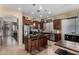 Well-appointed kitchen boasts stainless steel appliances, dark cabinetry, and a central island with seating at 14846 N 145Th Ave, Surprise, AZ 85379