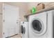 Modern laundry room features a Bosch washer and dryer, shelving, and ample storage space at 14846 N 145Th Ave, Surprise, AZ 85379