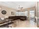 Open concept living room with neutral walls, tile flooring, and an open patio door at 14846 N 145Th Ave, Surprise, AZ 85379