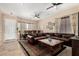 Bright living room with tile floors, ceiling fan and a leather sectional sofa at 14846 N 145Th Ave, Surprise, AZ 85379