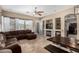 Open concept living room with neutral walls, tile flooring, and a built in fireplace at 14846 N 145Th Ave, Surprise, AZ 85379