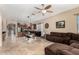 Bright open concept living room that flows into kitchen with stainless steel appliances at 14846 N 145Th Ave, Surprise, AZ 85379