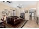Bright living room with tile floors, ceiling fan and a leather sectional sofa at 14846 N 145Th Ave, Surprise, AZ 85379