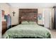 Comfortable bedroom showcasing a rustic wooden headboard and soft, inviting bedding at 14846 N 145Th Ave, Surprise, AZ 85379