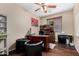 Comfortable office space with a large desk, black chairs, and wood floors at 14846 N 145Th Ave, Surprise, AZ 85379