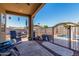 Covered patio with ceiling fan overlooking fenced pool and outdoor dining furniture at 14846 N 145Th Ave, Surprise, AZ 85379