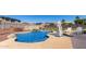 Backyard pool with rock waterfall feature, lounge area, and desert landscaping at 14846 N 145Th Ave, Surprise, AZ 85379