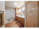 Modern bathroom with a glass-enclosed shower, dual sinks, and ample storage space at 14909 W Alpaca Dr, Sun City West, AZ 85375