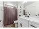 Bright bathroom featuring a marble-tiled shower and modern vanity with white cabinets at 15028 N 35Th Ave, Phoenix, AZ 85053