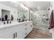 Well-lit bathroom with double sink vanity, marble-tiled shower with frameless glass doors at 15028 N 35Th Ave, Phoenix, AZ 85053