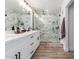 Stylish bathroom featuring a marble-tiled walk-in shower and a dual sink vanity at 15028 N 35Th Ave, Phoenix, AZ 85053