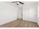 A clean, modern bedroom with sleek floors, a ceiling fan, and closet space at 15028 N 35Th Ave, Phoenix, AZ 85053