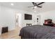 Comfortable bedroom with wood-look floors, a ceiling fan and a view into the home's hall at 15028 N 35Th Ave, Phoenix, AZ 85053