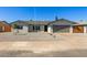 Charming single-story home with a gravel yard, wide driveway, and a gray two-car garage at 15028 N 35Th Ave, Phoenix, AZ 85053
