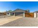 View of the home's front exterior, showcasing the garage, driveway, and rock landscaping at 15028 N 35Th Ave, Phoenix, AZ 85053