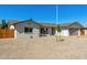 A well-maintained front yard features easy-care rock landscaping, a healthy tree, and privacy at 15028 N 35Th Ave, Phoenix, AZ 85053