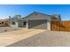 Home's gray garage and rock landscaping give this property a unique look and great curb appeal at 15028 N 35Th Ave, Phoenix, AZ 85053