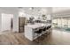Beautiful kitchen with stainless appliances, white cabinets, and a large center island with seating at 15028 N 35Th Ave, Phoenix, AZ 85053