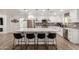 Bright kitchen features an island with seating, stainless steel appliances, and white cabinets at 15028 N 35Th Ave, Phoenix, AZ 85053