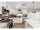 A full view of the kitchen, with a stainless steel oven, stove, dishwasher, and white countertops at 15028 N 35Th Ave, Phoenix, AZ 85053