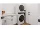 Convenient laundry area featuring white cabinets, countertop space, and a stacked washer and dryer at 15028 N 35Th Ave, Phoenix, AZ 85053