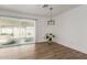 A light and airy living room with tile floors, white walls, and a large window to the yard at 15028 N 35Th Ave, Phoenix, AZ 85053