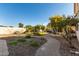 Expansive backyard featuring mature trees and a brick walkway at 16189 N 137Th Dr, Surprise, AZ 85374