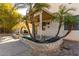 Backyard featuring mature palm trees, covered patio and brick pavers at 16189 N 137Th Dr, Surprise, AZ 85374