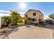 Spacious backyard featuring a lush tropical landscape and ample paved area at 16189 N 137Th Dr, Surprise, AZ 85374