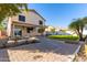 Large backyard showcasing a covered patio, mature trees, and brick pavers at 16189 N 137Th Dr, Surprise, AZ 85374