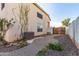 Lush landscaped backyard featuring a brick walkway and an AC unit at 16189 N 137Th Dr, Surprise, AZ 85374