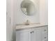 Bathroom featuring a white vanity, speckled countertop, modern faucet, and decorative mirror at 16189 N 137Th Dr, Surprise, AZ 85374