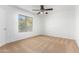 Bedroom with carpet, ceiling fan, and bright window providing views at 16189 N 137Th Dr, Surprise, AZ 85374