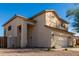 Exterior elevation of two-story tan home with desert landscaping at 16189 N 137Th Dr, Surprise, AZ 85374
