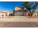 Charming two-story home with a well-maintained front yard and large driveway at 16189 N 137Th Dr, Surprise, AZ 85374