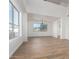 Spacious living room with wood floors, a large window, and a modern chandelier at 16189 N 137Th Dr, Surprise, AZ 85374