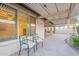 Charming backyard patio area with comfortable chairs and a beautiful pergola at 16372 W Mulberry Dr, Goodyear, AZ 85395