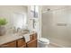 Well-lit bathroom features a vanity with sink and a glass-enclosed shower at 16372 W Mulberry Dr, Goodyear, AZ 85395