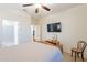 Bedroom with a ceiling fan, TV, and ensuite bathroom at 16372 W Mulberry Dr, Goodyear, AZ 85395