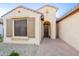 Inviting front entrance features an arched doorway and stone-paved walkway at 16372 W Mulberry Dr, Goodyear, AZ 85395