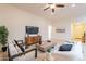 Bright living room featuring stylish furniture, a ceiling fan, and decorative accents at 16372 W Mulberry Dr, Goodyear, AZ 85395