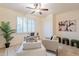 Bright and airy office space features tile flooring, a neutral color palette, comfortable seating, and a ceiling fan at 16372 W Mulberry Dr, Goodyear, AZ 85395